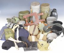 Collection of military equipment including German gas mask, water bottles, haversacks, cups, etc