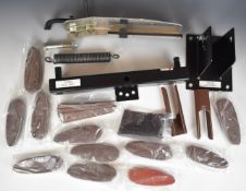 A portable shotgun clay pigeon trap together with 12 shotgun recoil pads, comb raisers and leather