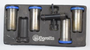 Four Beretta 20 bore shotgun chokes and choke key.
