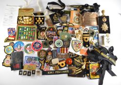 Large collection of cloth, metal and anodised badges, buttons and other militaria including Victoria