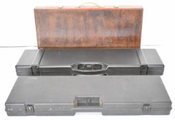 Three shotgun carry cases including one MGZ and one wooden, largest 90cm long.