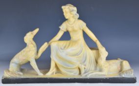 Art Deco figure of a lady kneeling with two dogs, height 34cm
