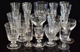 Eighteen Georgian / Victorian glass drinking glasses including rummers, a near set of six flutes