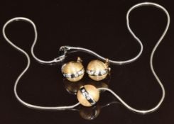 A yellow and white metal pendant and matching earrings set with diamonds on white metal chain (