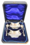 Edward VII cased pair of twin handled salts and spoons, Birmingham 1902, maker William Aitken,