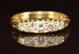 An 18ct gold ring set with five diamonds, 3.7g, size L