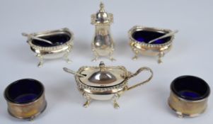 Hallmarked silver salts, mustard and pepper comprising a pair of circular examples and a four