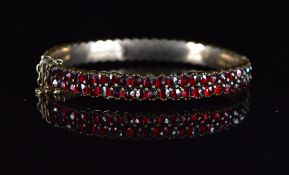 Silver gilt bangle set with Bohemiam cut garnets, 18.2g, 4.5 x 5.8cm