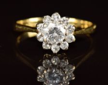An 18ct gold ring set with a diamond of approximately 0.6ct surrounded by diamonds, 3g, size N