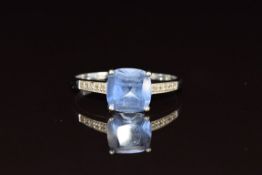 A 9ct white gold ring set with a cushion cut tanzanite and diamonds, 2.1g, size S