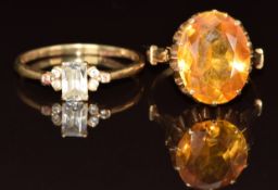 A 14k gold ring set with an oval cut yellow sapphire (4.8g, size K) and a 14k gold ring set with