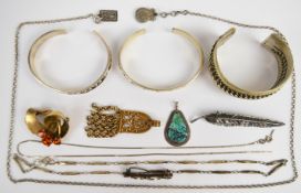 A collection of silver jewellery including three bangles, brooch in the form of three swallows set