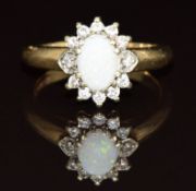 A 9ct gold ring set with an opal surrounded by diamonds, 3.2g, size K