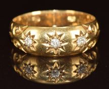 A c1910 18ct gold ring set with three old cut diamonds in star settings, 4.2g, size R