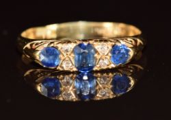 An 18ct gold ring set with three sapphires and diamonds, Birmingham 1920, 3.3g, size Q