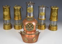 Five miner's lamps including Thomas and Williams, Cambrian, Lamp and Limelight Company etc, and a