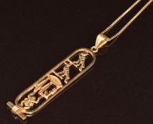 An 18ct gold Egyptian pendant (4.5g) on 18ct gold chain, 5.6g, 48cm