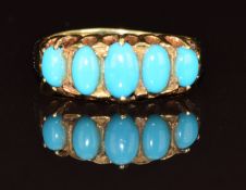 An 18ct gold ring set with five turquoise cabochons, 2.5g, size J