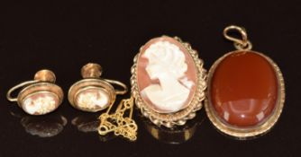 A 9ct gold brooch set with a cameo with similar earrings and a 9ct gold pendant set with amber, 13.