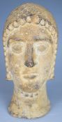 Etruscan stone votive bust wearing head dress with chin strap and hollow base, possibly Cyprus /
