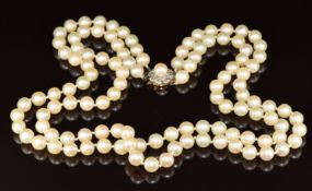 A double strand of cultured pearls, the 9ct gold clasp set with a pearl surrounded by rose cut