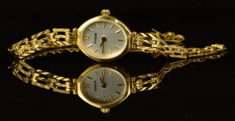 Accurist 9ct gold ladies wristwatch with gold hands and hour markers, silver dial and quartz