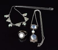 A 9ct gold ring set with an opal cabochon surrounded by paste in a silver setting and two silver