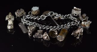 A silver charm bracelet with thirteen silver charms including a bear, four by Chim and one by