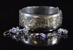A silver bangle and three pairs of silver earrings set with tanzanites, 42g