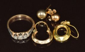 A 9ct gold ring set with three diamonds (2.2g, size J) and four single 9ct gold earrings (3.1g)