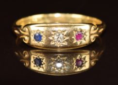 An 18ct gold ring set with a diamond, sapphire and ruby, all in star settings, 3.1g, size R