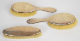 Three hallmarked silver mounted brushes, Birmingham 1918, maker Charles S Green & Co Ltd, length