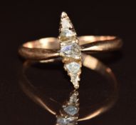 A yellow metal ring set with four diamonds in a marquise shaped setting (one glass replacement), 2.