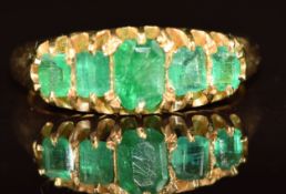 A Victorian 18ct gold ring set with five emerald cut emeralds, Chester 1895, 4.1g, size L