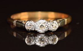 An 18ct gold ring set with three diamonds in a platinum setting, 2.5g, size P