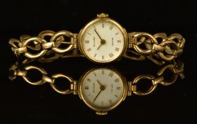 Accurist 9ct gold ladies wristwatch with gold hands and Roman numerals, white dial and quartz