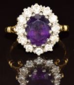 An 18ct gold ring set with an oval cut amethyst surrounded by diamonds, of approximately 0.04ct, 5.