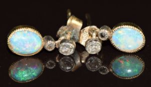 A pair of Victorian / Edwardian earrings each set with an opal cabochon and two old cut diamonds,