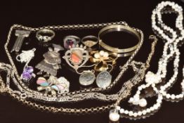 A collection of silver jewellery including five chains, two pendants, two brooches, christening