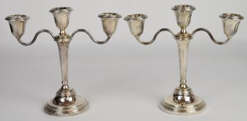 Pair of Elizabeth II hallmarked silver three branch candelabra, the central sconce unscrewing to