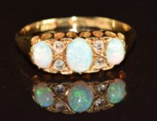 Edwardian 18ct gold ring set with three opals and four rose cut diamonds, 3.1g, size O