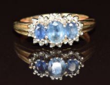 A 9ct gold ring set with three oval cut sapphires surrounded by diamonds, 2.5g, size J