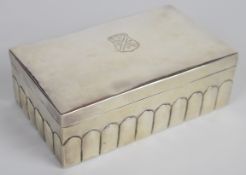 White metal cigarette box with embossed decoration and engraved coat of arms to lid, length 15.5cm