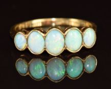 An 18ct gold ring set with five oval opal cabochons, 2.4g, size N