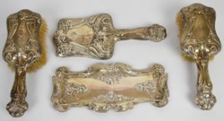 Art Nouveau hallmarked silver dressing table set comprising hand mirror, tray and a pair of brushes,