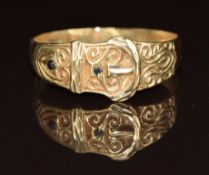 A 9ct gold buckle ring set with two garnets, 2.3g, size T