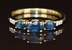 A 9ct gold ring set with three oval cut sapphires and Australian diamonds, 2.4g, size P