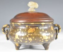 Chinese gold splash bronze tripod censer with twin handles, hardwood cover with carved jade finial