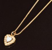 Edwardian 9ct gold pendant in the form of a heart set with a heart cut opal surrounded by seed
