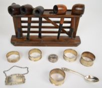 Hallmarked silver bottle ticket for Sherry, napkin rings, spoon, pipe rack with five pipes including